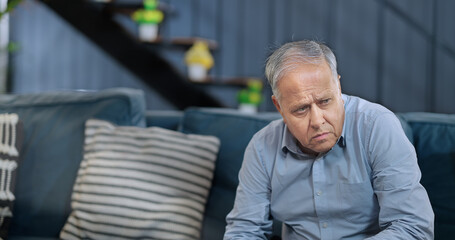 Worried retired Asian old senior man sitting alone sofa couch feel bad sorrow anxiety at indoor home. Indian elder aged Gray haired gen x male sad lonely pensive suffer ill health issues problem - obrazy, fototapety, plakaty