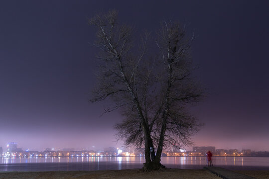 Scenic view of the city of Dnepr in the winter evening. Dnipro in the evening. Ukrainian city in winter at night. background image. Panoramic view. Long exposure photo of the Dnieper River at night.
