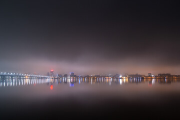 Scenic view of the city of Dnepr in the winter evening. Dnipro in the evening. Ukrainian city in winter at night. background image. Panoramic view. Long exposure photo of the Dnieper River at night.