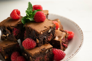 Chocolate brownie with raspberries and cashews.