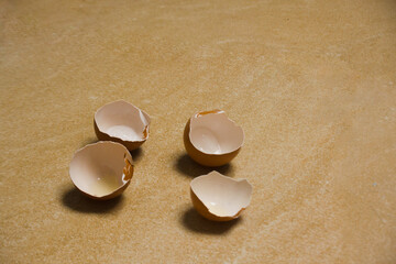 The brown eggshell is split in half