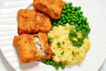 fried fish with mashed potatoes and green peas