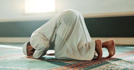 Praying, Muslim and man with faith in a mosque for praying, peace and spiritual care in holy...