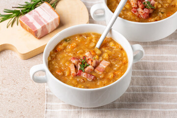 Creamy yellow split pea soup with smoked bacon, ham. Homemade comfort food.