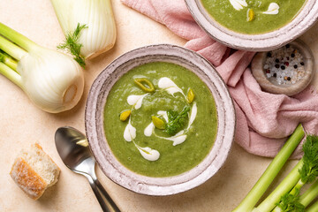 Creamy vegetable fennel, leek and spinach soup with vegan cream. Top view. Fresh bread.