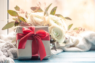 Obraz na płótnie Canvas Festive background with gift box and flowers.