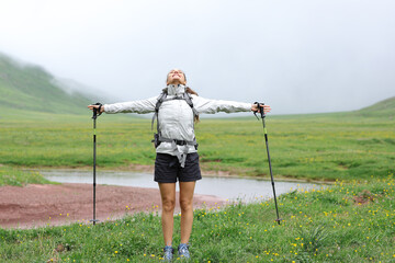 Hiker celebrating vacation in a valley © PheelingsMedia
