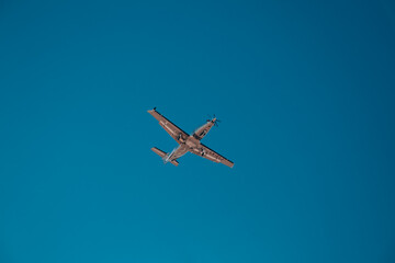 Italy, Lombardy, Milan 14.12.2023. Propeller plane at the blue sky. Airplane against blue sky. The plane lands at the Italian airport Linate