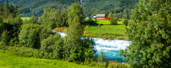 Fototapeta na wymiar Norwegian landscape with river, summer mountains and village in Olden, Norway