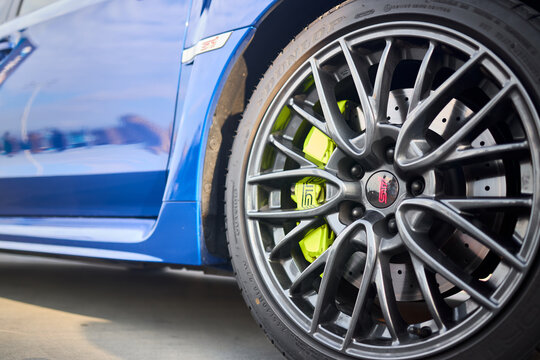 Berlin, Germany - August 20, 2022: Subaru Impreza WRX Sti detail shot. Sti badges logo emblem on wheel plug and on wing selective focus close up.