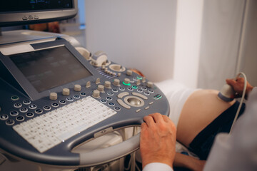 In the Hospital, Close-up Shot of the Doctor does Ultrasound Sonogram Procedure to a Pregnant...