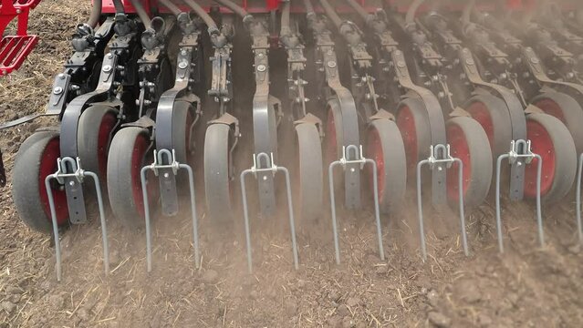 Farming Cultivator at Work, Close-up of a cultivator machinery in a farm field.