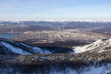 View from the mountain to the city of Magadan. A large northern city located on the sea coast among the mountains. Beautiful northern nature. Magadan, Magadan region, Russian Far East.