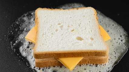 Cooking on grill cheese sandwich, close up