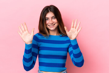 Young caucasian woman isolated on pink background counting ten with fingers