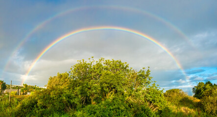 Spectacular double rainbow over the picturesque landscapes of rural inland Algarve, Portugal