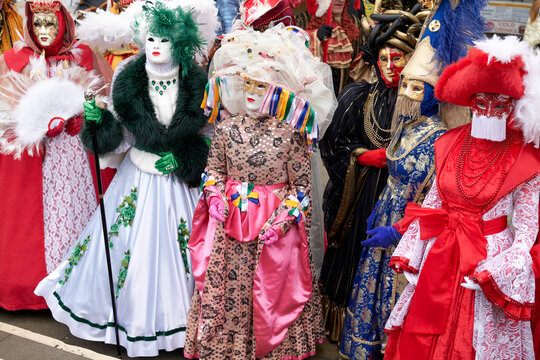 Venice, Italy - February 2024 - carnival masks are photographed with tourists in San Marco square