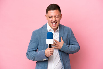 Young brazilian presenter man isolated on pink background smiling a lot