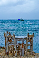wooden chair on the beach and boat 