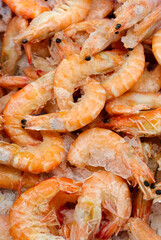 Frozen prawns on a market counter