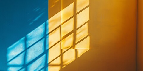 Sunshine and sky shining through window with outlines of window frame on golden wall.
