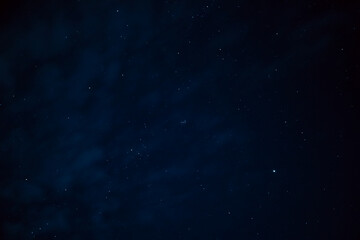 Night sky - Universe filled with stars. Stars in the night sky through the clouds