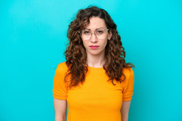 Young caucasian woman isolated on blue background With glasses