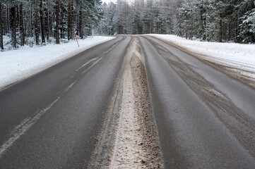 Winter road through forest in Hallsberg Sweden