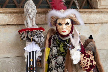 Fototapeta na wymiar Venice, Italy - February 2024 - carnival masks are photographed with tourists in San Marco square