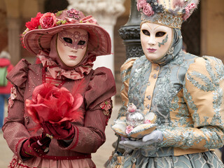 Venice, Italy - February 2024 - carnival masks are photographed with tourists in San Marco square