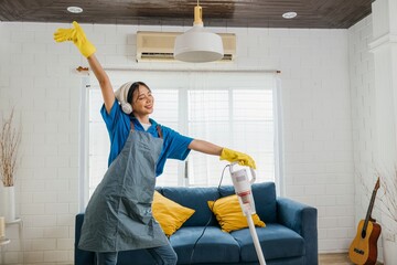 Asian housewife's cheerful cleanup, mop mic in hand singing dancing happily. Fun-filled service with music humor. Modern housework excitement. Give me melody, maid dancing having fun