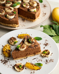 Fototapeta na wymiar Delicious and fluffy chocolate mousse cake with banana and orange aroma.