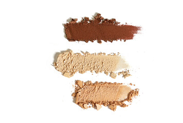 Brown, golden, nude shimmering eye shadow texture swipe isolated on white background. Cosmetic product brush swatch