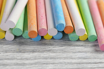 Multicolored pastel colours chalks on a textured board close up