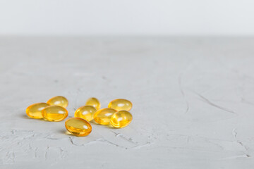 Cod liver oil omega 3 gel capsules on colored background with copy space. Heap of Omega 3 soft gel capsules