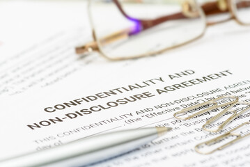 Blue pen on a confidentiality and non-disclosure agreement form. A confidentiality and non-disclosure agreement form safeguards sensitive information, outlining obligations, exceptions, and remedies.