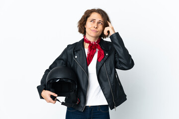 English woman holding a motorcycle helmet isolated on white background having doubts and thinking