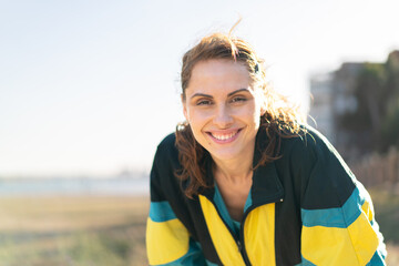 Young woman at outdoors wearing sport wear with happy expression