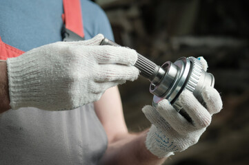 The chassis of the car. Suspension repair. In the hands of an auto mechanic, a hinge with equal...