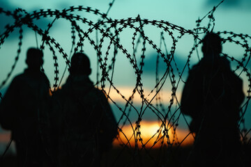 Barbed Wire Silhouette Against Twilight Sky for Security and Border Control Editorial Use