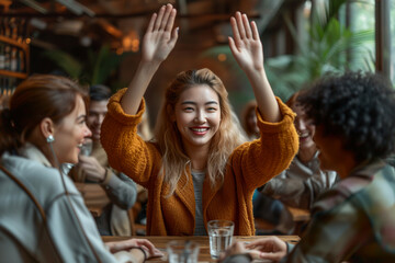 Multiracial euphoric team people give high five at cafe table, happy excited diverse work group engaged in teambuilding celebrate corporate success win partnership power teamwork concept