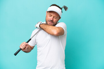 Middle age caucasian golfer player man isolated on blue background suffering from pain in shoulder...