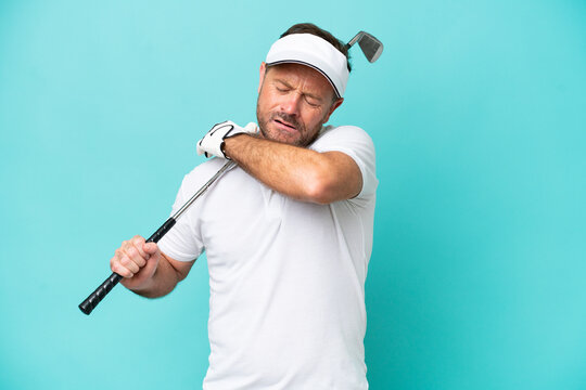 Middle age caucasian golfer player man isolated on blue background suffering from pain in shoulder for having made an effort