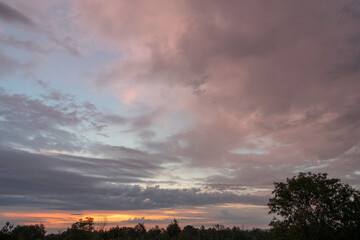 Alençon, France - 08 18 2023: Sky Background. Detail view of a cloudscape with colored clouds and...