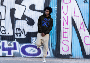 Mockup of man wearing customizable hoodie by graffiti