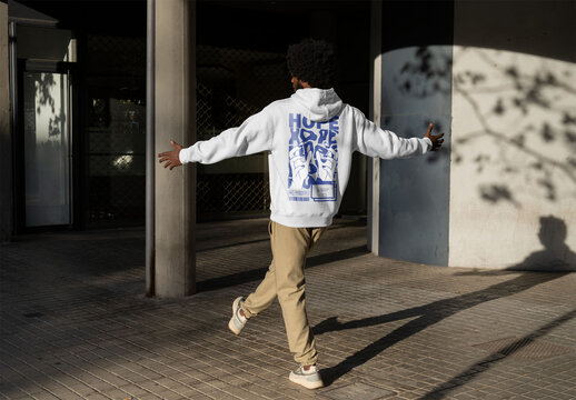 Mockup of man wearing customizable hoodie, rear view