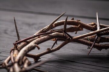 Christian crown of thorns on dark desk background