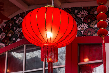 Traditional glowing red paper lantern in street decorations in Moscow in connection with the celebration of the Chinese New Year. Close up. Moscow, Russia - 733805557