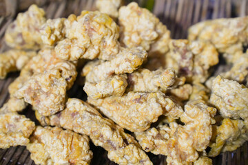 Close up of Chinese food: Deep fried pork belly，Sichuan snacks, with a crunchy exterior and juicy interior.