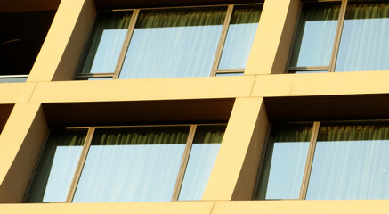 Abstract image of looking up at modern glass and concrete building. Architectural exterior detail of office building.